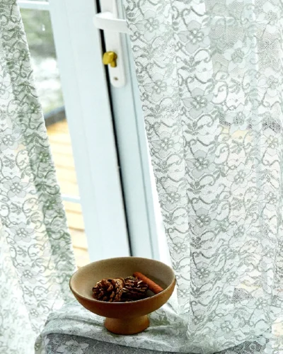 Sheer Botanical Lace Curtain with Natural Light and Decorative Bowl