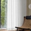 Jacquard Sheer Curtain with geometric leaf texture hanging beside a neutral wall and diffuser set