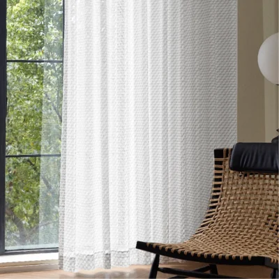Jacquard Sheer Curtain with geometric leaf texture hanging beside a neutral wall and diffuser set