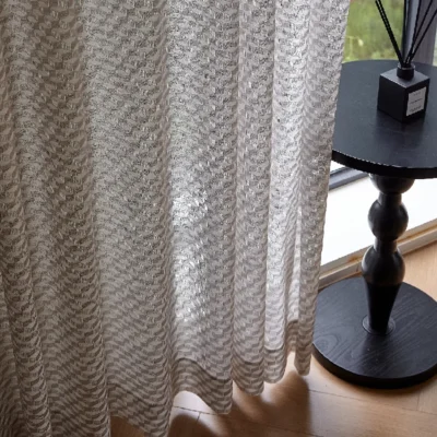 Light filtering jacquard curtain with geometric weave and soft shadows