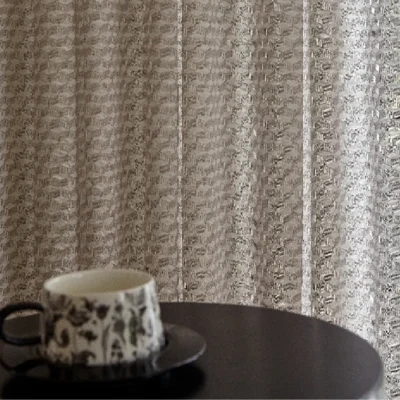 Jacquard curtain backdrop with coffee cup on table