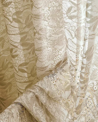 Close-up of dual-tone jacquard sheer curtain with leaf pattern in beige tone.