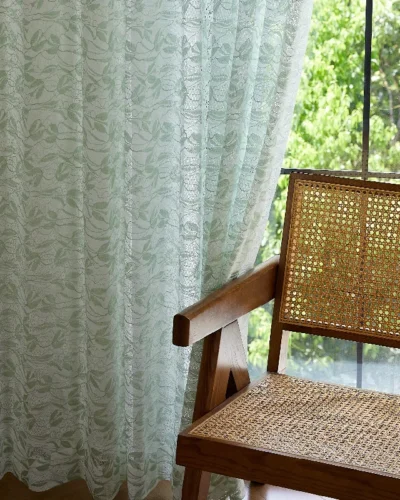 Willow Whisper Curtain hanging beside a wooden chair in soft daylight.