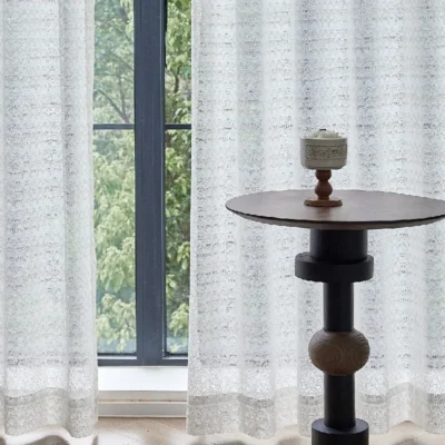 White jacquard sheer curtain with ripple or oval pattern, softly filtering light