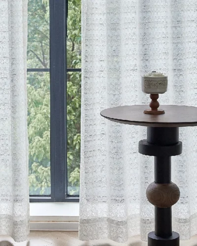 White jacquard sheer curtain with ripple or oval pattern, softly filtering light