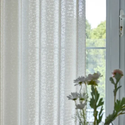 Echo Leaf Curtain hanging beside a window, gently filtering daylight with subtle jacquard leaf texture