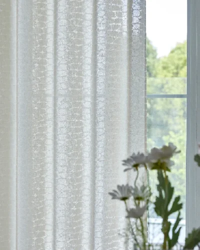 Echo Leaf Curtain hanging beside a window, gently filtering daylight with subtle jacquard leaf texture