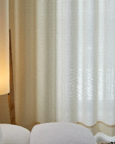 Echo Leaf sheer curtain softly glowing under warm interior light