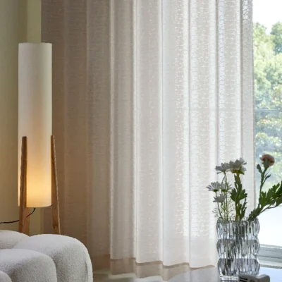 Echo Leaf Curtain softly draped with warm indoor lighting and natural daylight
