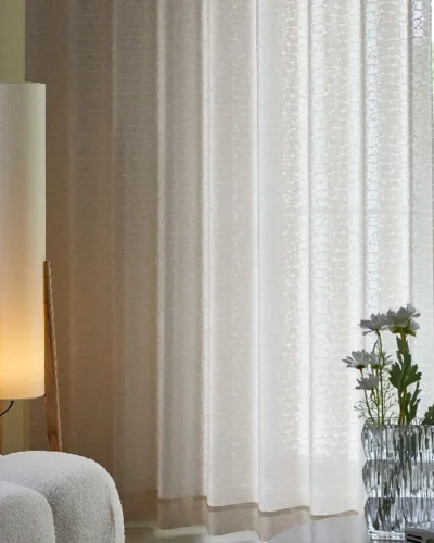 Echo Leaf Curtain softly draped with warm indoor lighting and natural daylight