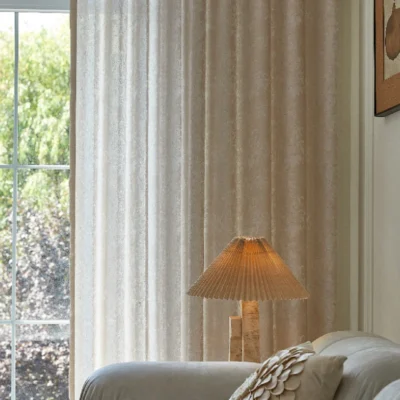 Light-filtering floral curtain with soft texture in a warm-toned room
