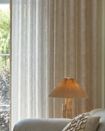 Light-filtering floral curtain with soft texture in a warm-toned room