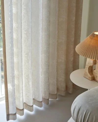 Floral jacquard curtain filtering sunlight in a modern cozy room