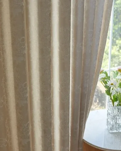 Soft jacquard curtain panel with floral texture beside window and vase