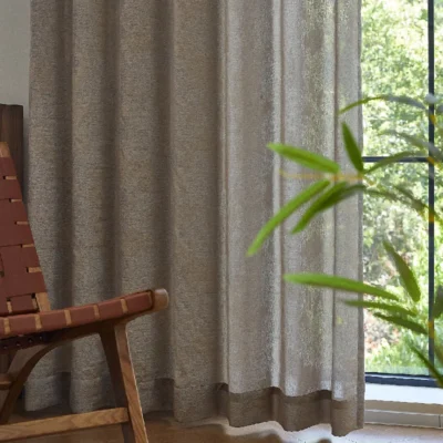 Dual veil jacquard curtain in taupe tone with soft light filtering, styled with wood chair and plant
