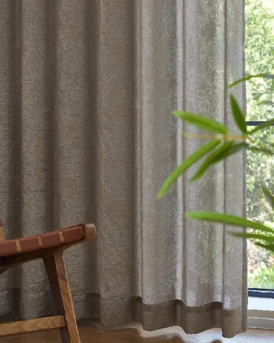 Dual veil jacquard curtain in taupe tone with soft light filtering, styled with wood chair and plant