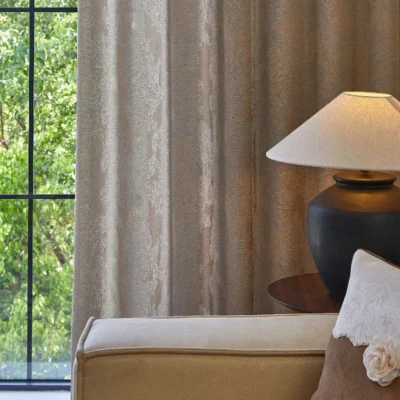 Dual veil jacquard curtain in beige filtering daylight in a modern bedroom