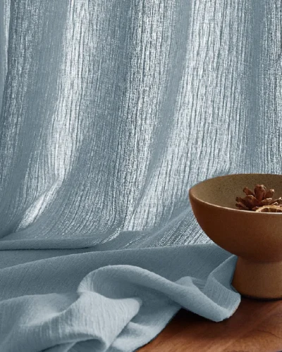 Blue chenille sheer curtain with soft texture and natural light filtering