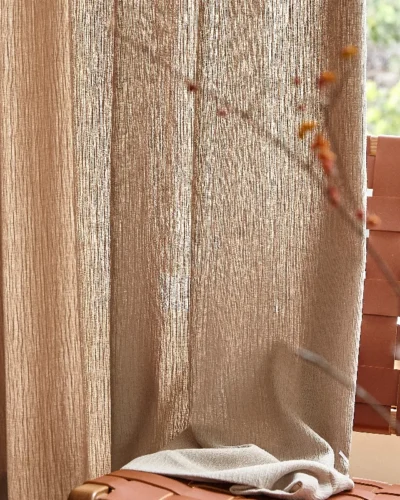 Natural brown chenille sheer curtain with textured weave and filtered sunlight