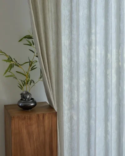 Zen bamboo jacquard sheer curtain beside a wooden cabinet with indoor plant