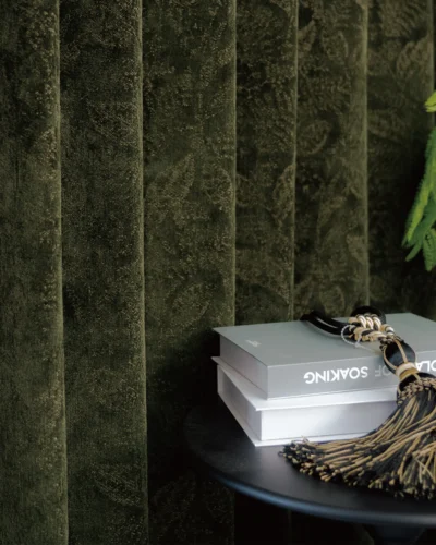 Leafshadow Jacquard Curtain with textured botanical weave, styled with books and a tassel in a calm reading corner by Lemonho