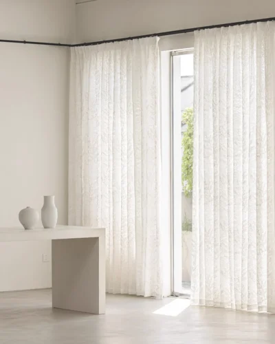 Rope-embroidered floral sheer curtain in ivory, softly filtering daylight.