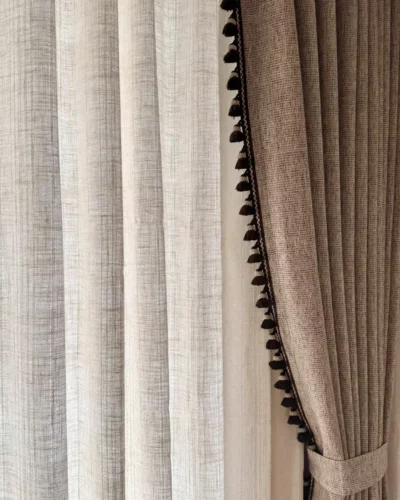Cocoa fringe jacquard linen-cotton chenille curtain layered with white sheers, showing tassel trim edge