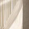 Soft beige floral jacquard shade curtain draped by a window, textured fabric with gentle light.