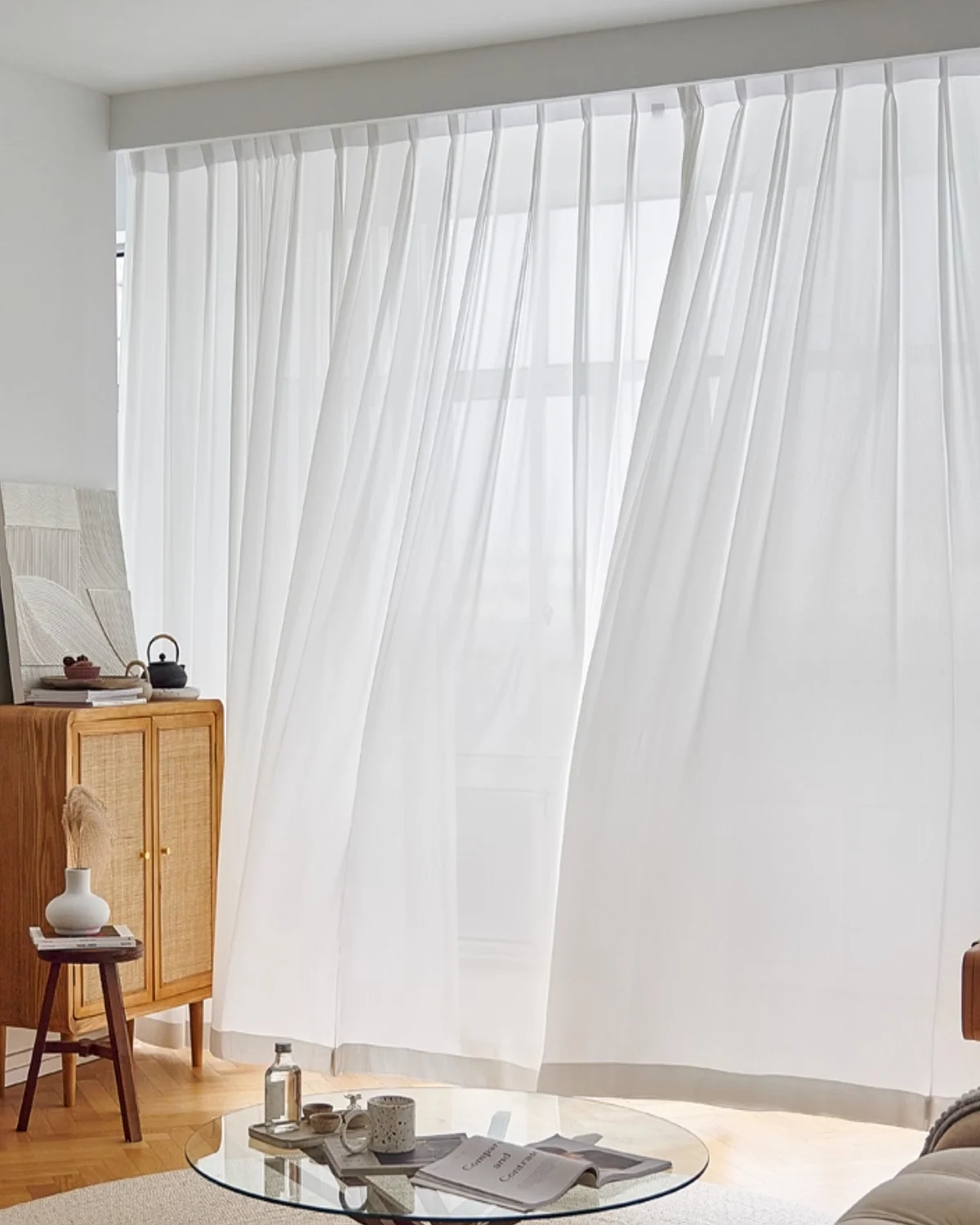 Fine Ridge Texture Curtain in soft matte ivory billowing gently by an open living room window beside a low coffee table.