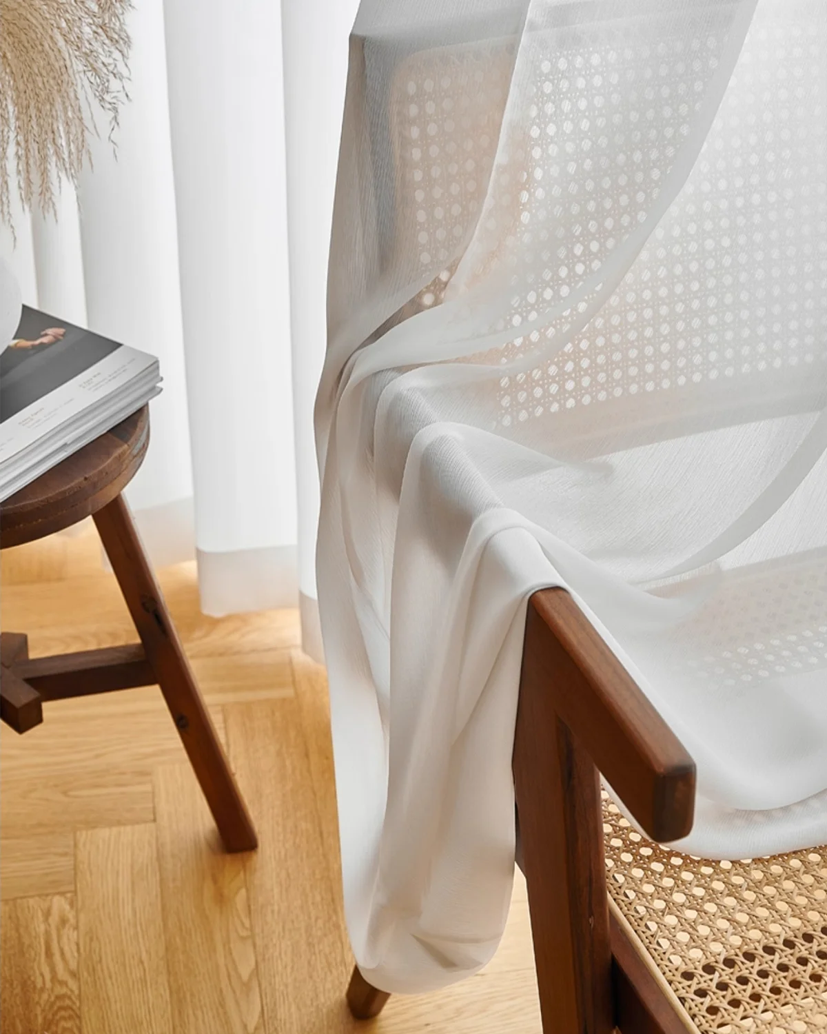 Fine Ridge Texture Curtain in soft matte ivory pooling softly on the floor beside a wooden chair.