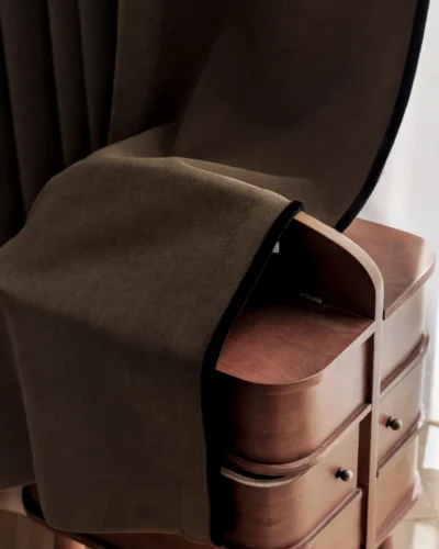 Mocha blackout curtain draped over a chair showing thick room-darkening fabric