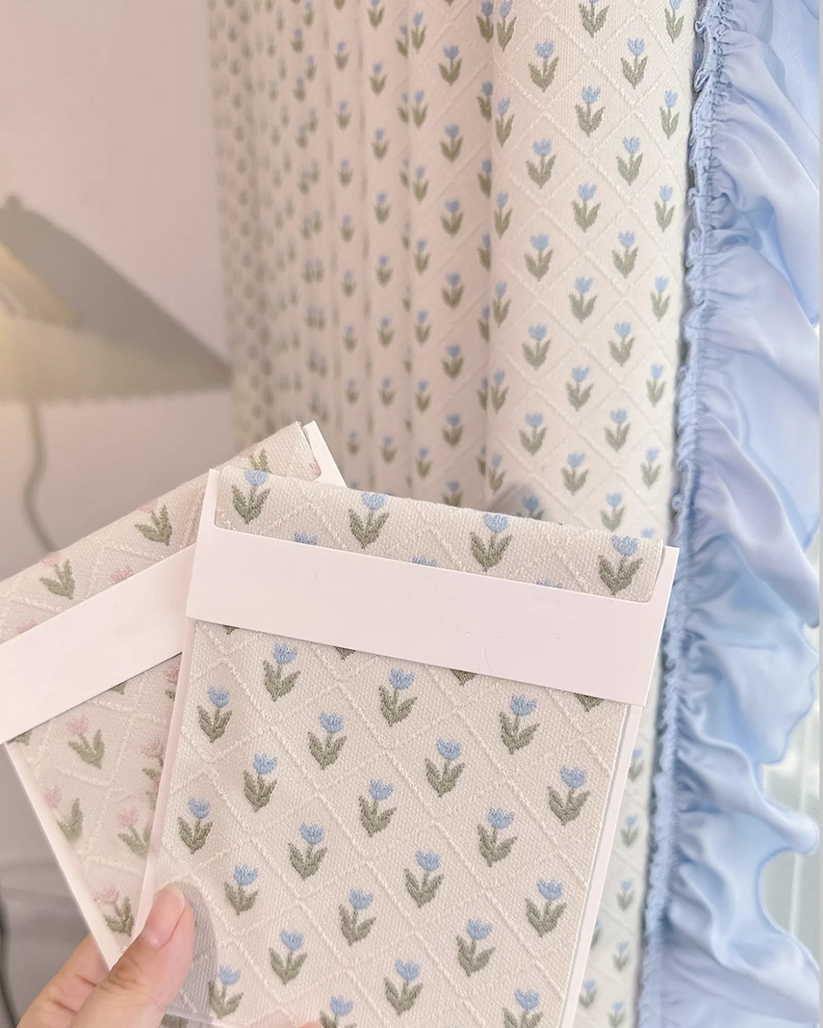 Matching fabric accessory with petite floral pattern styled with embroidered sheer curtain