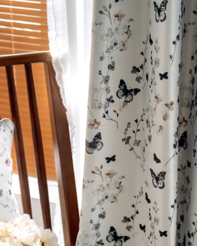 Close-up of butterfly print curtain with floral details, softly lit by natural daylight.
