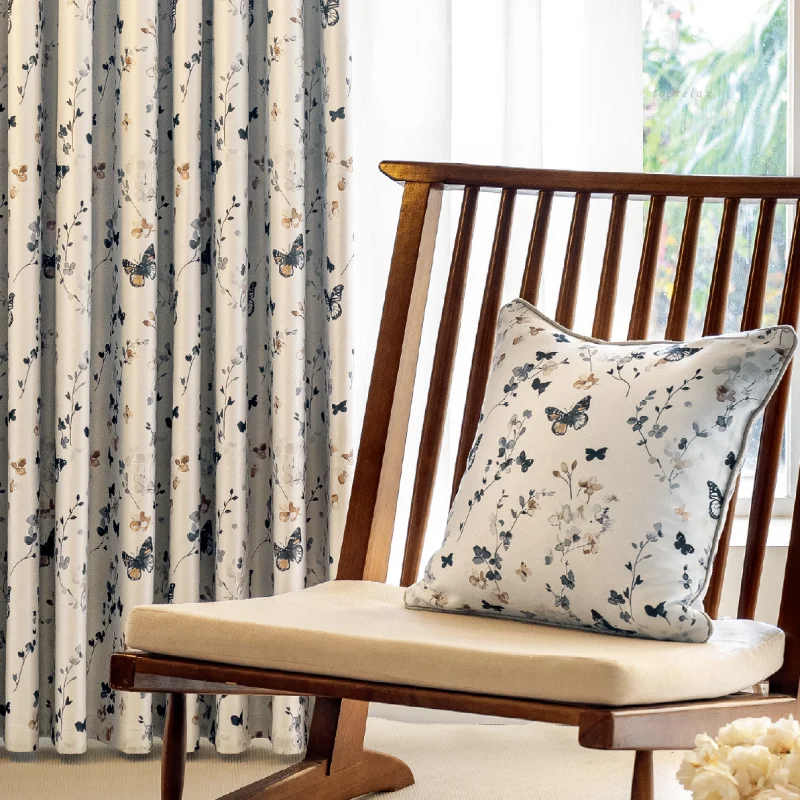 Butterfly print curtains in a bright, cozy room with wooden chair and soft natural light.