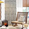 Butterfly print curtains styled in a cozy living space with natural light and wooden furniture.