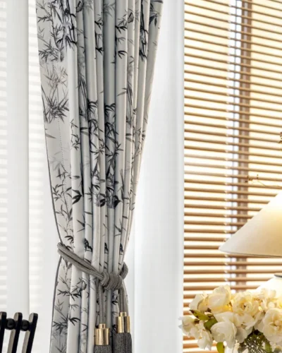Ink bamboo curtain pulled open beside window with natural light and floral decor