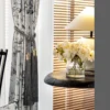 Close-up of ink bamboo curtain with pleats, styled with flowers and wood decor