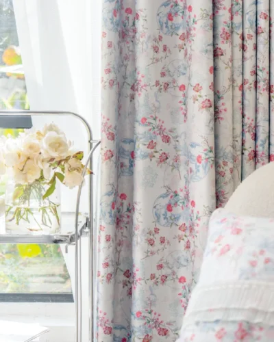 Botanical print curtain with bird and floral motifs, sheer white layer, and soft accents.