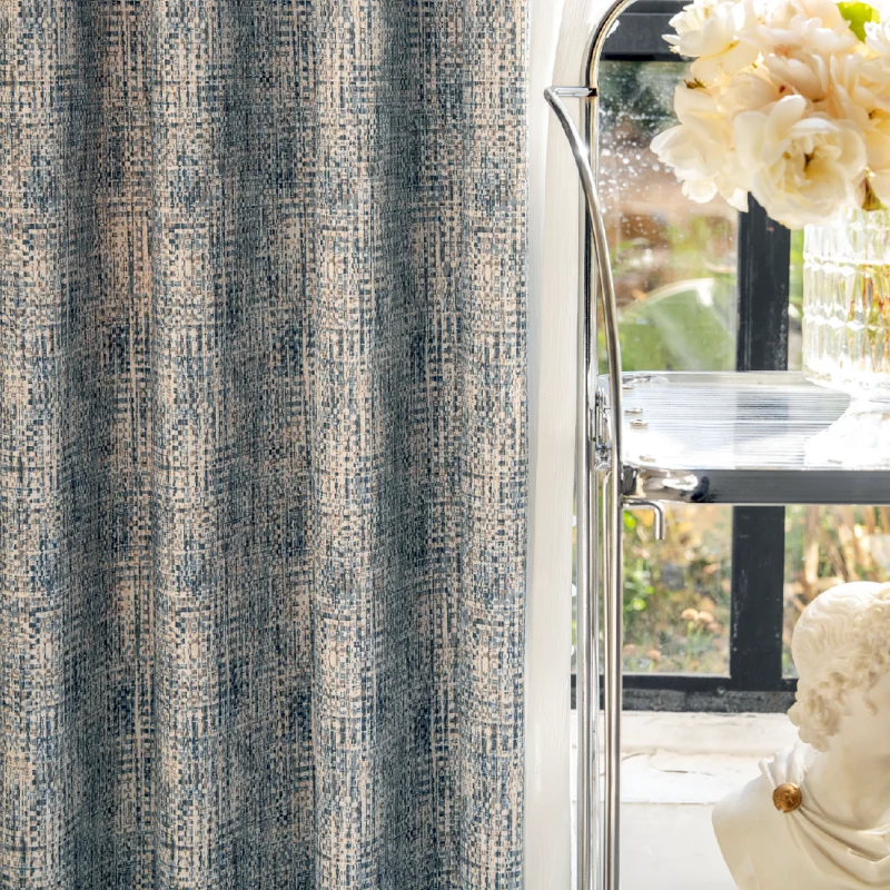 Woven Print Curtain in indigo and beige with faux textured pattern, softly draped near a window with natural light and floral decor