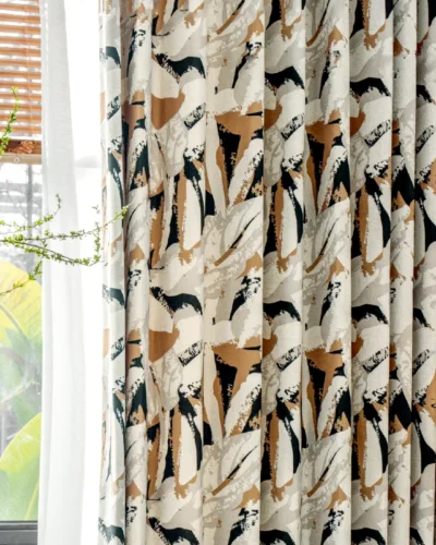 Close-up view of Painter’s Bloom curtain with bold abstract floral print near a sunny window.