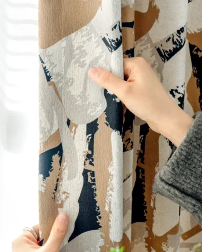 Close-up of Painter’s Bloom curtain fabric being held to show texture and pattern.