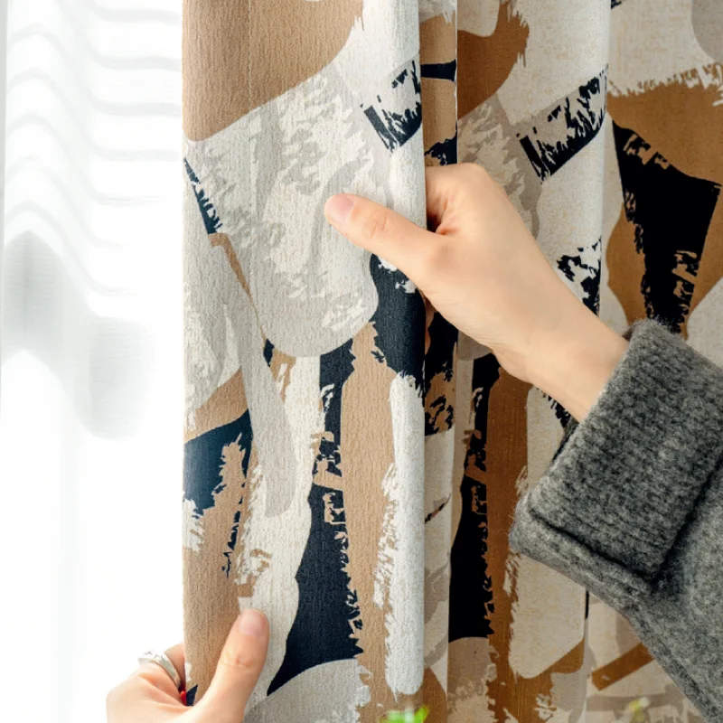 Close-up of Painter’s Bloom curtain fabric being held to show texture and pattern.