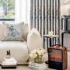 Watercolor floral curtain in soft blue and blush tones, styled in a modern living room with neutral sofa and floral décor – Dreamy Meadow collection.