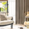 Gold-tone texture curtain in modern living room with soft fabric glow and layered decor.