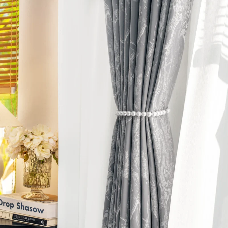 Grey stone vein jacquard curtain with tieback, layered with white sheer drape in natural light