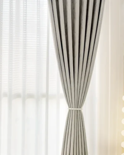 Ivory gold jacquard curtain with stone vein texture, tied back to reveal sheer white layer