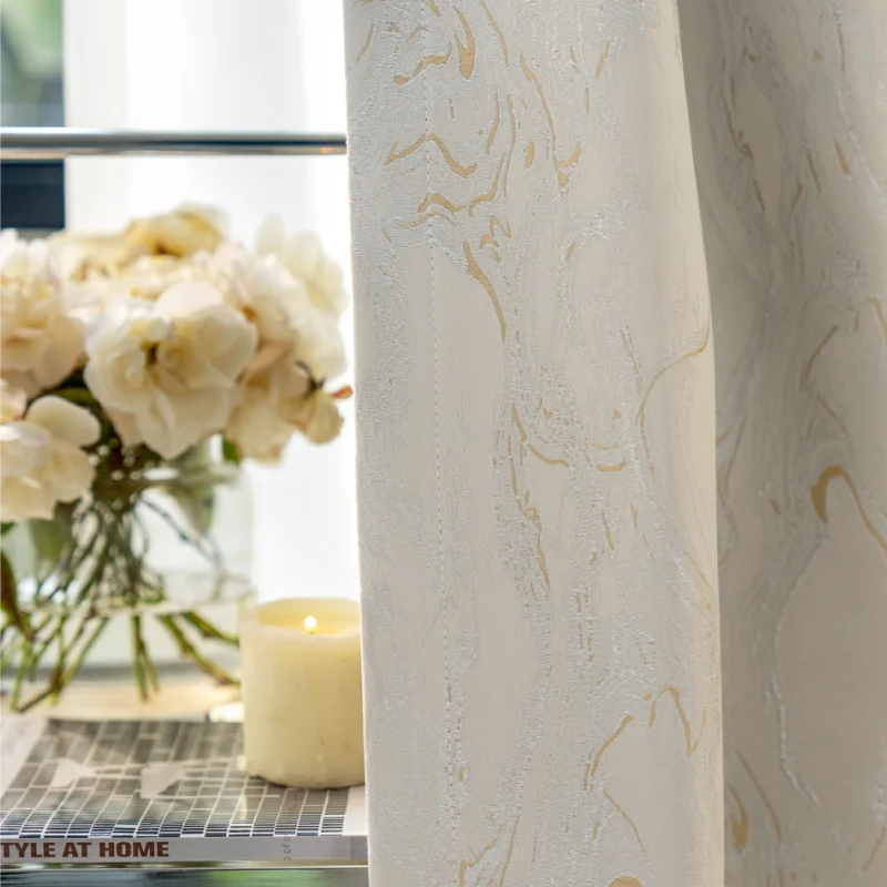 Ivory gold jacquard curtain with subtle stone vein texture and floral decor background