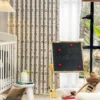 Cartoon car print curtain in nursery room with blackboard and baby crib