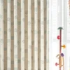 Side view of smiling cloud curtain layered with white sheers in kids room