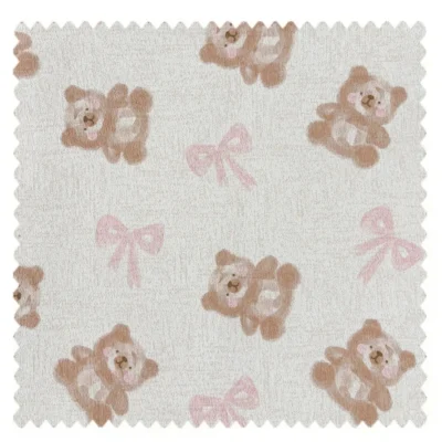 Teddy bear and pink bow print fabric swatch on white background